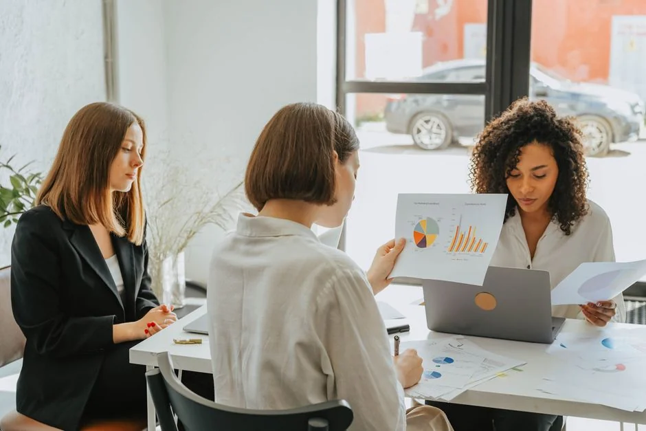Group of business professionals collaborating in an office setting.